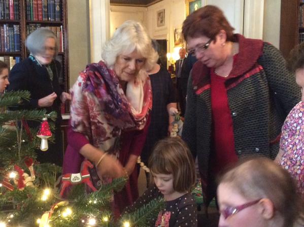 Camilla decorating Christmas tree with children